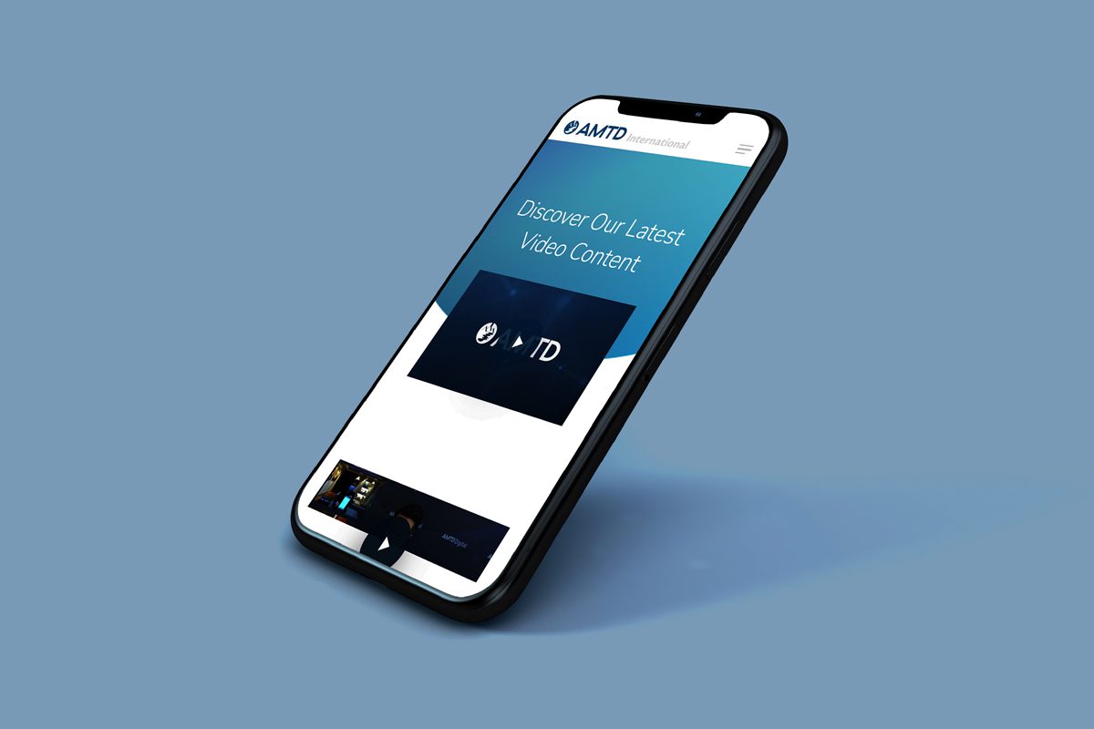 AMTD International website shown on phone on blue background
