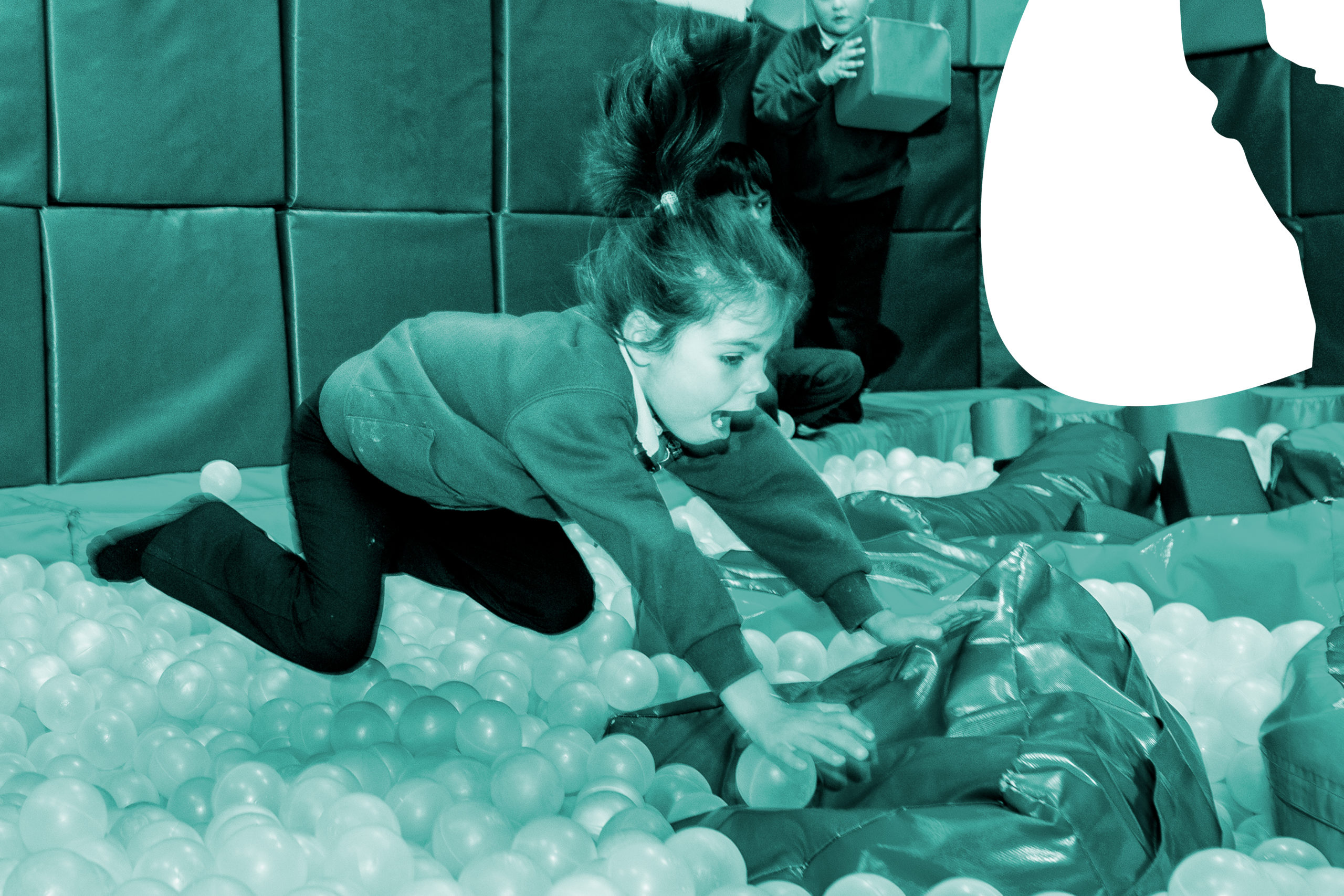 Girl jumping into the ball pit with green filter