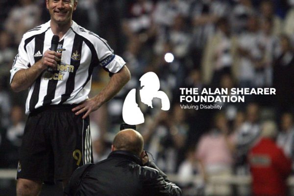 Alan Shearer Foundation white logo on a scene during a football match