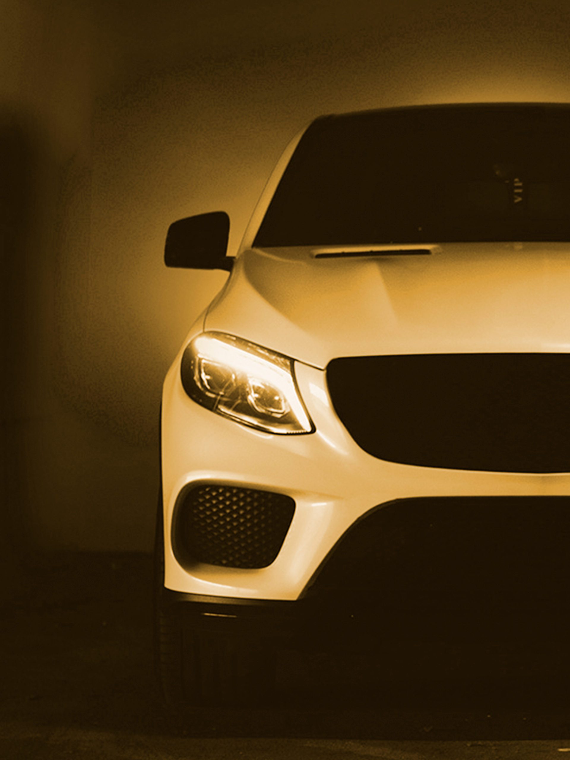 Car 2 scaled White Car with lights on with yellow filter