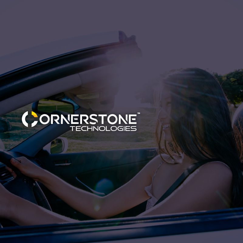 Cornerstone Technologies logo designed by ipulse creative agency Hong Kong overlays on top of an image of a happy woman driving a sustainable and innovative electric car