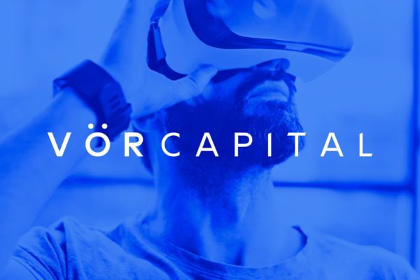 VOR Capital logo designed by ipulse creative agency Hong Kong overlays on top of a blue background image with a man wearing an innovative VR goggle