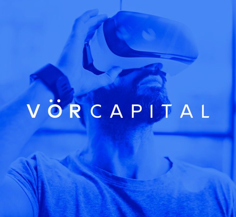 VOR Capital logo designed by ipulse creative agency Hong Kong overlays on top of a blue background image with a man wearing an innovative VR goggle