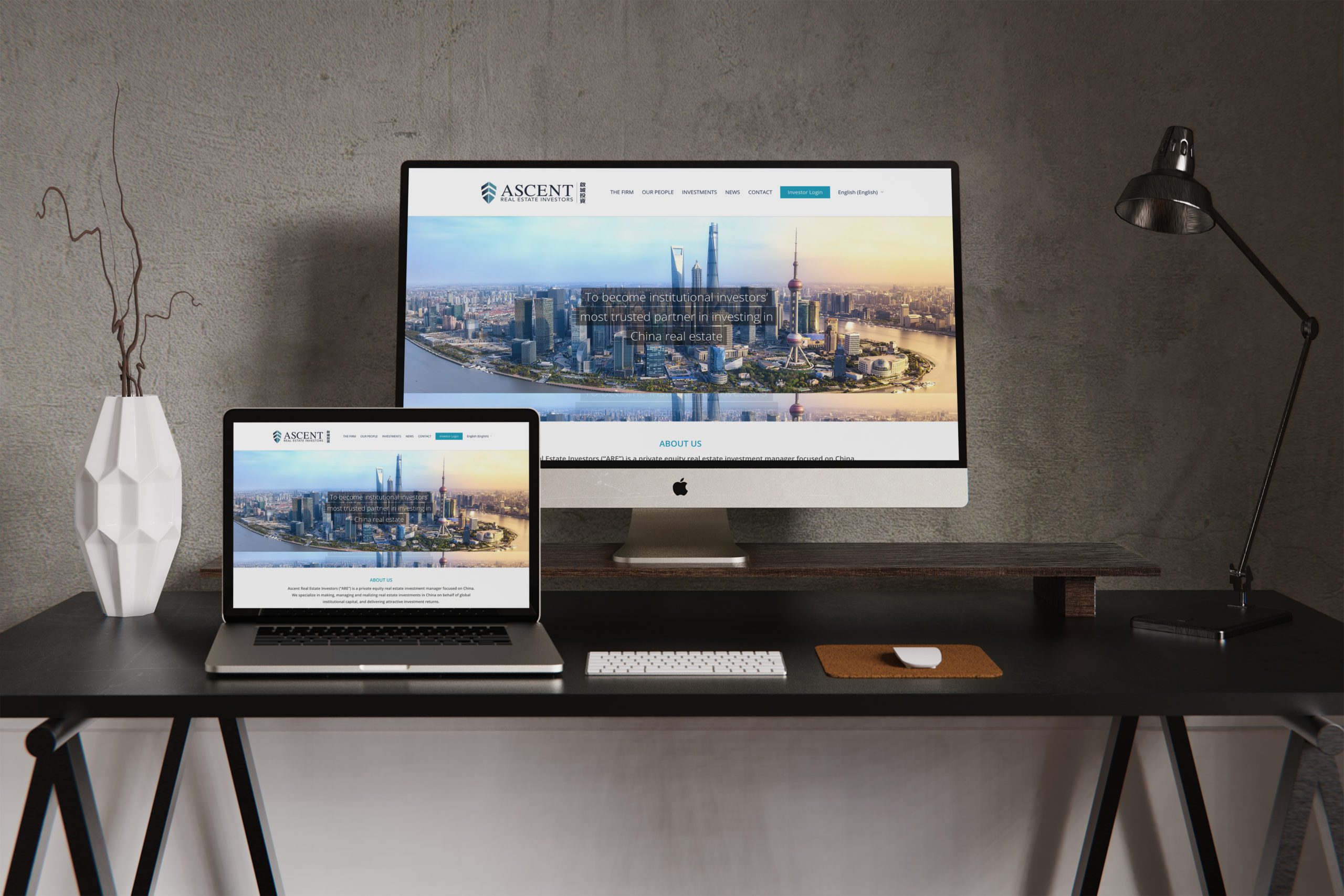 Ascent website shown on laptop and on desktop with a work desk background