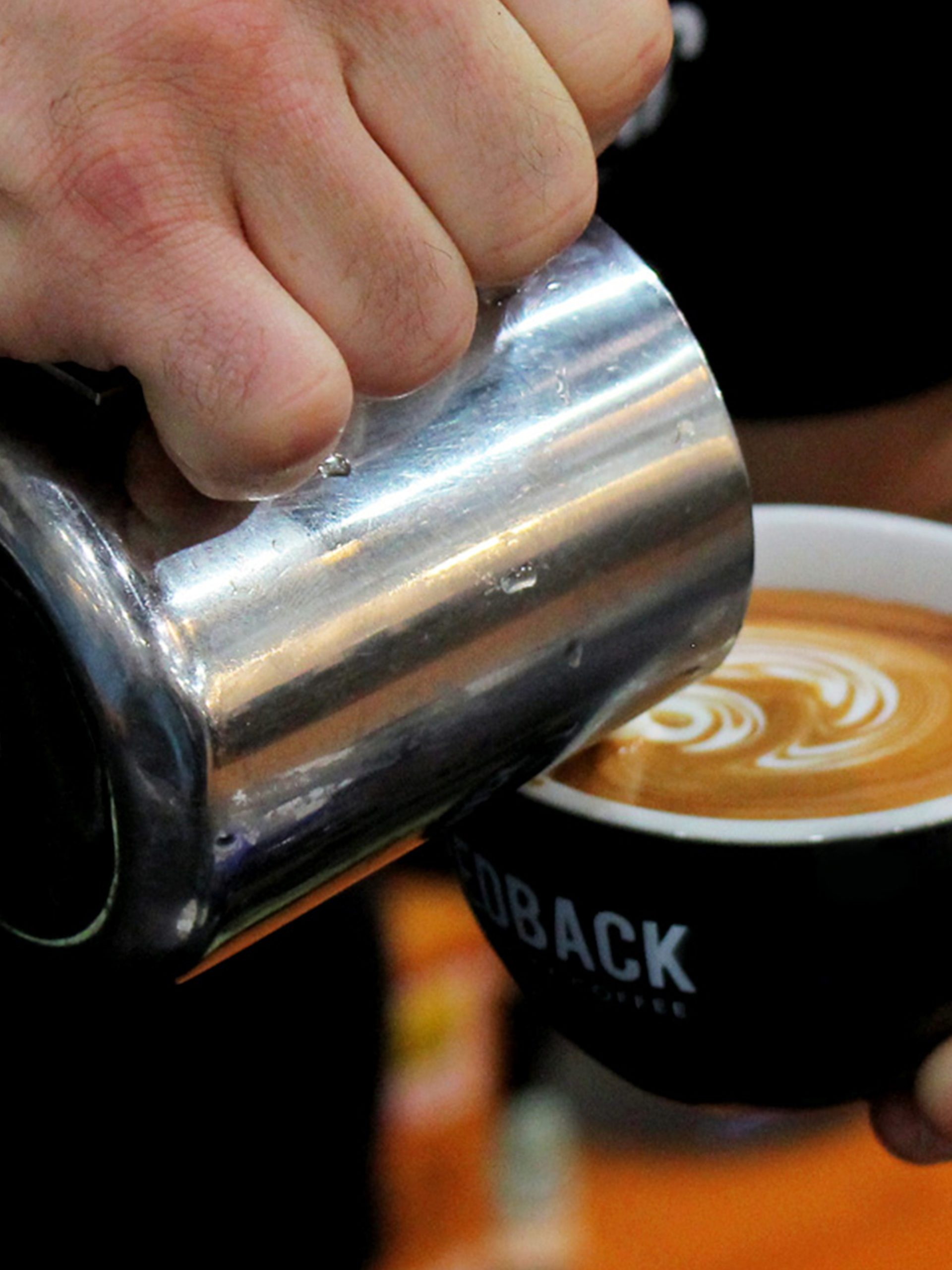 Redback Coffee barista making latte art