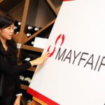 Mayfair Branding woman looking at Mayfair logo
