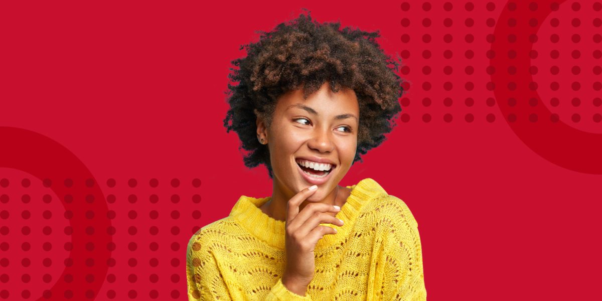 Young black lady smiling on a red background with ipulse branding assets