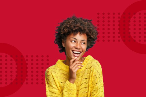 Happy and cheerful woman on a red background wearing a yellow jumper representing ipulse creative agency Hong Kong has successfully supported start-up businesses throughout the year 2021