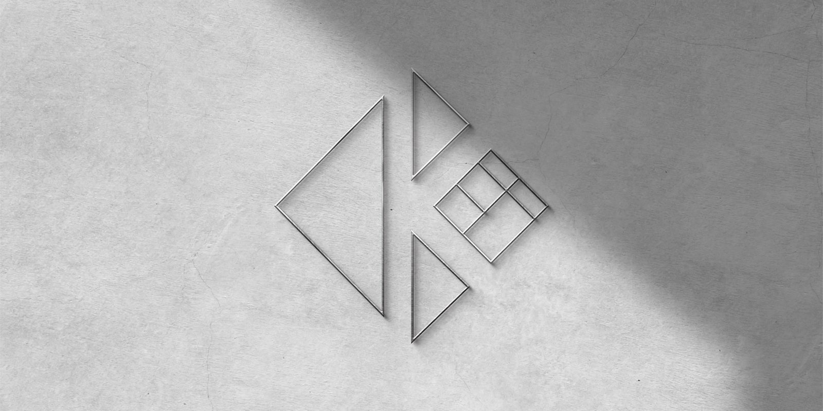 Kubes 3D metal logo on wall with soft sunlight